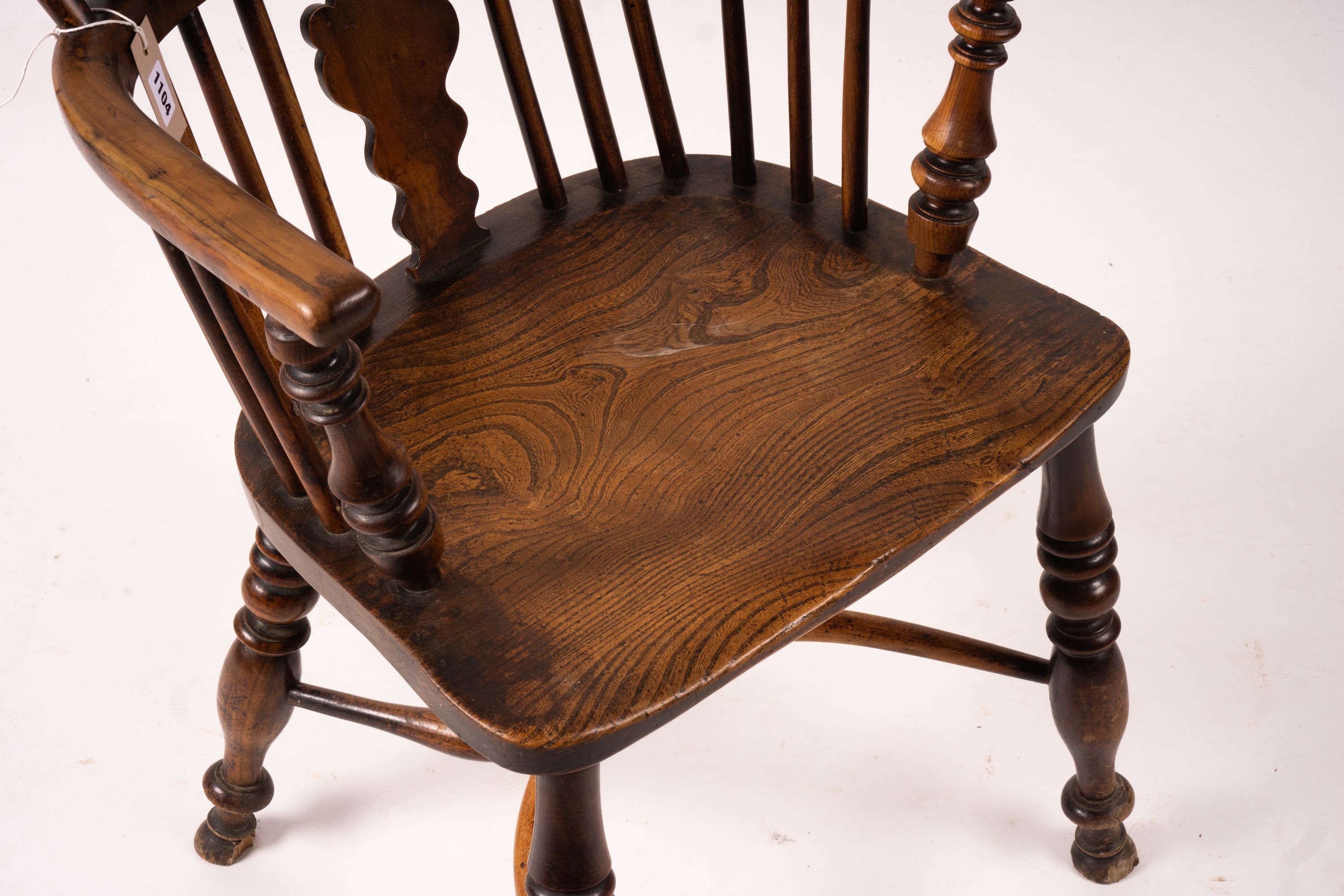 A mid 19th century yew and elm Windsor elbow chair with crinoline stretcher, width 54cm, depth 46cm, height 94cm